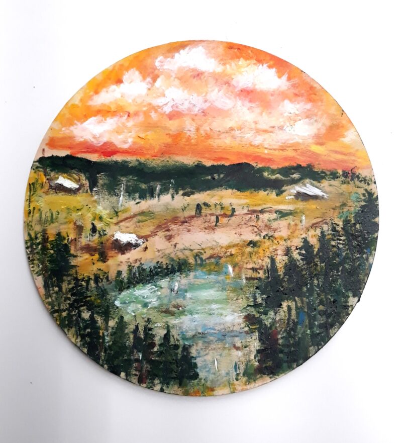 A round painting of a landscape with yellow-orange sunset sky.
