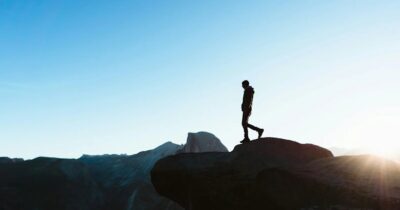 A photo of someone standing on a mountain.